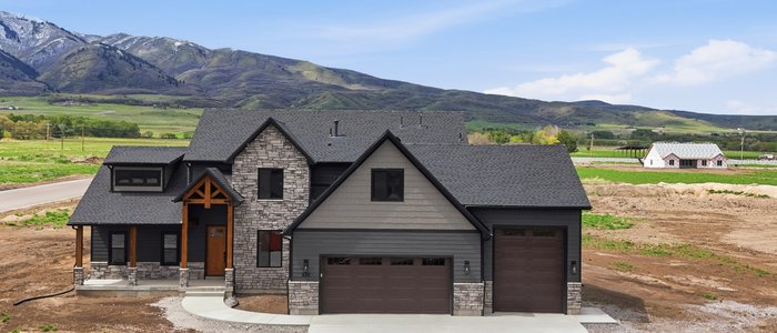 Hamilton plan home built by Red Clover Homes in Mendon, Utah, with the Wellsville Mountains in the background